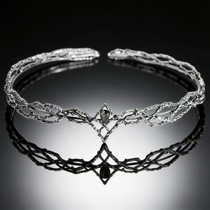 Detailed close-up of a silver elf crown featuring a black teardrop-shaped gemstone inlay
