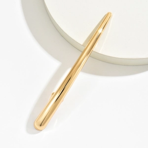 Minimalist gold metal shark hair claw clip with sleek streamlined long design