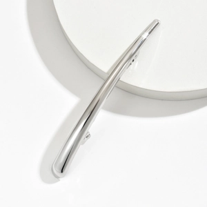 Minimalist silver metal hair clip with polished streamlined design and spring clip