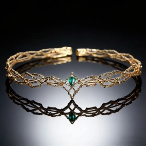 Detailed macro view of golden fantasy elf tiara with green teardrop gemstone inlay
