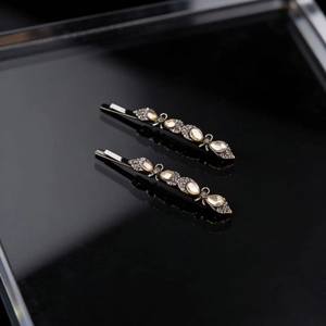Elegant black hair clip set with champagne teardrop gems and sparkling rhinestones