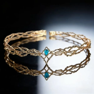 Detailed view of a golden elf crown with intricate metal vines and a blue teardrop gemstone
