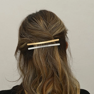 Minimalist gold and silver zinc alloy hair clips shown on brown wavy hair in close-up