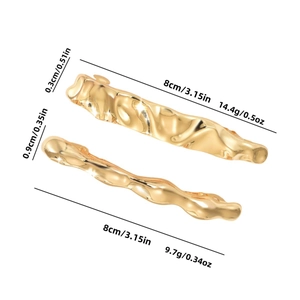 Golden alloy liquid lava hair clips with metallic wavy texture on white background