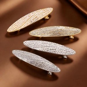 Set of four vintage hair clips with rhinestones and pearls on premium silk background