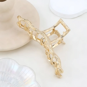 Elegant gold metal shark hair clip with textured branch design for messy bun hairstyles