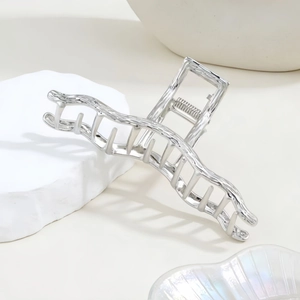 Silver liquid metal claw clip with minimalist wave texture for elegant hairstyling