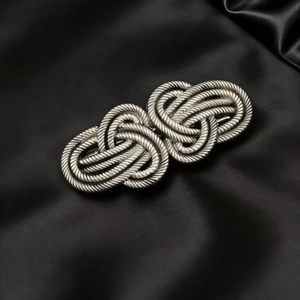 Vintage silver alloy hair clip with Celtic knot design on elegant black silk background