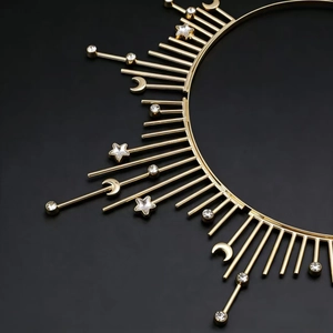Golden sunburst celestial headband featuring star and moon charms with sparkling crystals