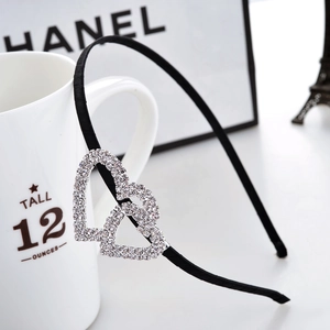 Elegant black satin headband with sparkling rhinestone double heart charm detail