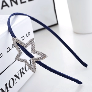 Detail of dark blue satin headband with a sparkling rhinestone-studded star design