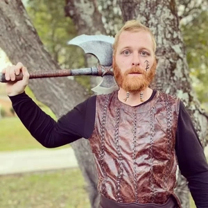 Viking warrior costume featuring brown leather vest and large double-headed battle axe prop