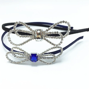 Close-up of rhinestone bow headbands featuring white and blue center gemstones
