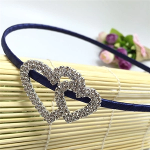Close-up of dark blue satin headband with double crystal-encrusted hearts detail