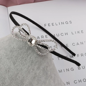 Elegant thin black headband with a sparkling rhinestone bow and crystal center detail