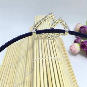 Detailed view of dark blue fabric headband with silver geometric rhinestone pattern inlay