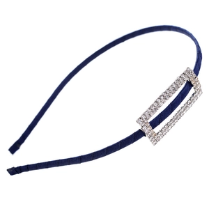 Detail of navy blue satin headband featuring a sparkling rectangular rhinestone ornament