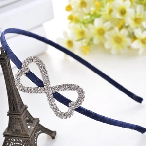 Detail of elegant navy satin headband featuring a sparkling infinity rhinestone design