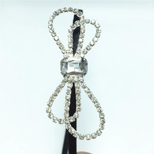 Macro detail of sparkling rhinestone bow headband with a center rectangular gemstone