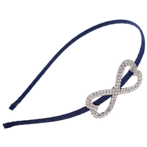 Detailed close-up of a blue fabric headband featuring a heart-shaped silver rhinestone motif