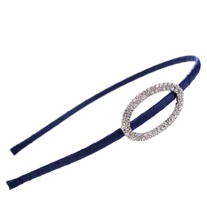 Close-up of navy blue satin headband featuring sparkling oval rhinestone decoration