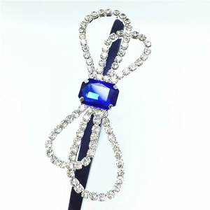 Detail of elegant bow headband with navy blue gemstone and sparkling silver rhinestones