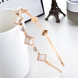 Detail of rose gold metal headband with pearls and crystals on a white ceramic cup
