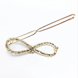 Elegant gold infinity hair clip with sparkling rhinestones for women's fashion styling