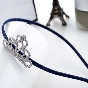 Navy blue satin headband with a sparkling rhinestone crown ornament for a sweet hair style