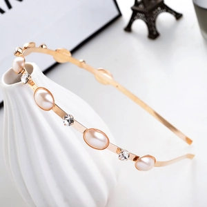 Minimalist gold headband featuring elegant rows of pearls and sparkling rhinestones