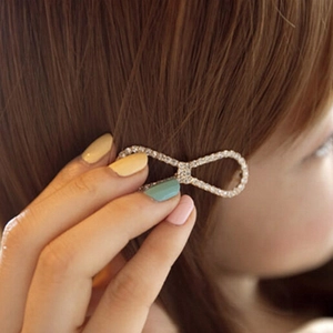 Bow hair clip with sparkling rhinestones set on brown hair for elegant styling