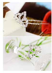 Detail view of a silver crown hairpin with sparkling rhinestones and U-shaped pins