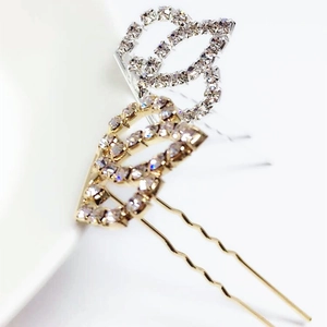 Close-up of elegant U-shaped hairpins with sparkling rhinestones in gold and silver
