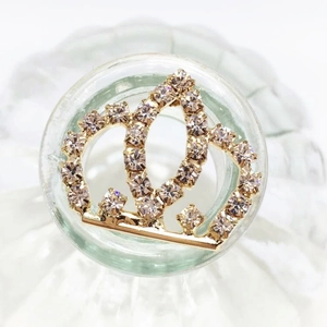 Detailed close-up of golden crown hair accessory with sparkling crystal rhinestones