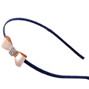Serre-tête bleu marine orné d'un nœud en métal or rose avec des strass étincelants