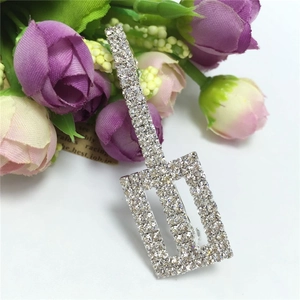 Detailed macro view of silver rhinestones encrusted on a geometric rectangular hair clip