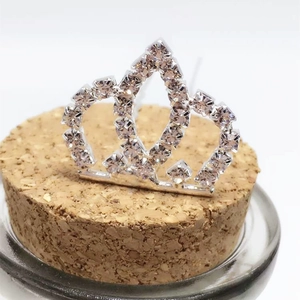 Macro shot of silver crown accessory with pavé rhinestones on a cork stand