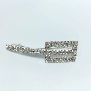 Macro detail of silver rectangular BB hair clip with rows of sparkling rhinestones