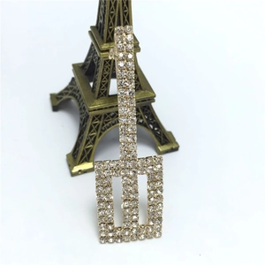 Close-up of a sparkling rhinestone hair clip with geometric rectangles and gold finish