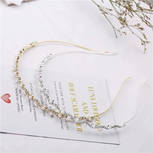 Detail of elegant gold and silver wavy headbands with sparkling rhinestones and pearls