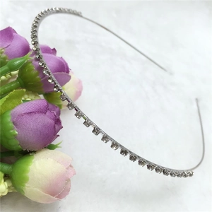 Close-up of slim silver headband featuring a single row of sparkling clear rhinestones