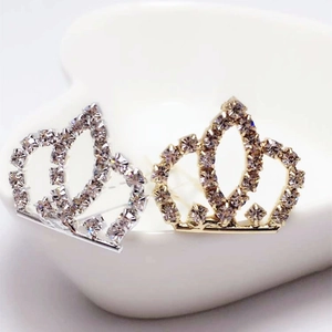 Detail of gold and silver crown hairpins with sparkling rhinestones for bridal hairstyles