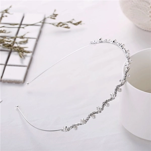 Detail of silver wavy headband with white pearls and sparkling rhinestones inlay