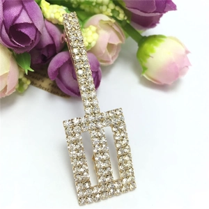 Close-up of a sparkling rhinestone hair clip with rectangle geometry on a floral base