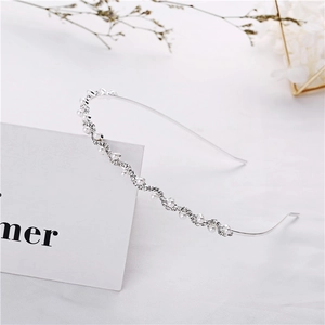 Elegant silver wavy headband featuring white pearls and sparkling rhinestones for women