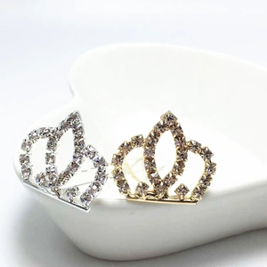 Detailed macro view of gold and silver crown hair clips with sparkling rhinestones