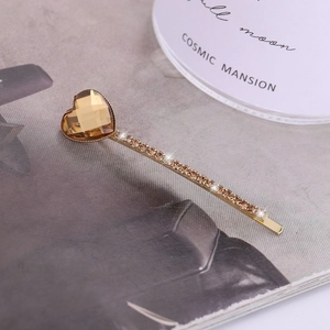 Vintage gold hair clip featuring a large amber heart crystal and champagne rhinestones