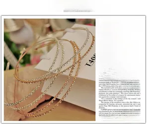 Close-up of gold and silver slim headbands set with sparkling single row crystal rhinestones