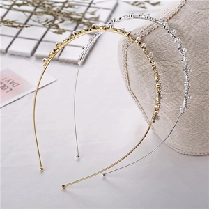 Close-up of gold and silver thin headbands with inlaid pearls and sparkling rhinestones