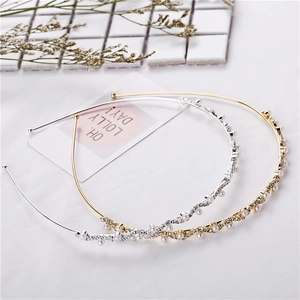 Detailed macro view of gold and silver wavy headbands with pearls and crystals
